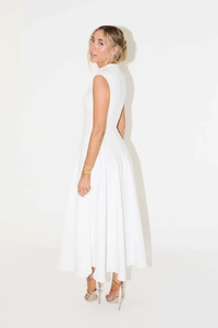 Detail view of white sleeveless maxi dress with elegant high waist and large flowing hemline