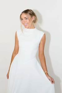 Detail view of white sleeveless high-neck dress with elegant A-line silhouette and waist fit