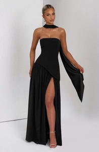 Detail view of black strapless evening dress featuring a high slit and matching choker neckband