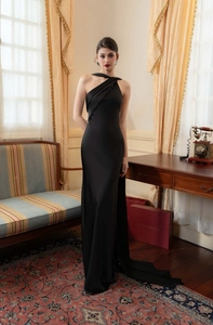 Detail of elegant black satin evening dress with ruched silhouette and fishtail hem