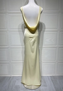 Detail of elegant backless satin dress in cream yellow showing draping neck folds