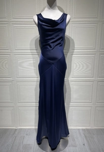 Detailed view of the cowl neck and draped satin bodice on this dark blue evening gown