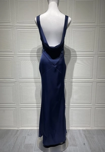 Rear view of dark navy satin backless evening gown on mannequin with glossy finish