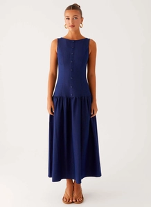 Detail of dark blue sleeveless dress showing button-down front and dropped waist design