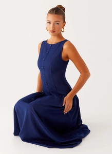 Close-up of deep navy blue sleeveless denim dress with front button closure details
