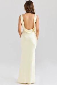 Detail view of smooth backless design and draped satin fabric on the cream evening dress