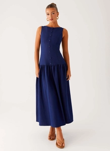 Detailed close-up of navy blue sleeveless midi dress with decorative button down front