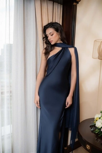 Detail of dark blue satin gown featuring elegant one-shoulder draping and matching shawl