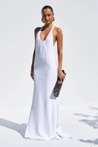 Detail of elegant white silk maxi dress with deep V-neck and halter strap design