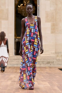 Detail of sleeveless maxi dress featuring a vibrant geometric print and deep U-neckline