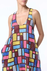 Detail of summer sleeveless maxi dress with colorful geometric patterns and linen texture