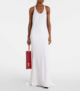 Detail of elegant white halter neck maxi dress with deep U-neckline and smooth fabric draping