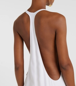 Detail view of the elegant open-back white dress featuring thin straps and smooth fabric