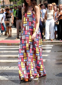 Street style shot of sleeveless maxi dress with colorful geometric art print and loose fit