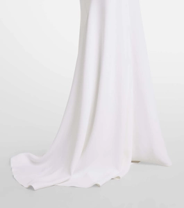 Detail shot of the elegant white maxi dress hem with smooth matte fabric and soft drapes