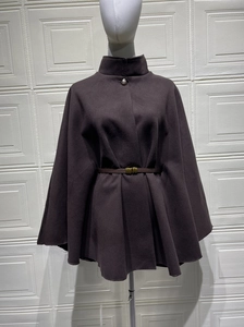 Detail of elegant wool cape coat collar with metal button and slim leather belt