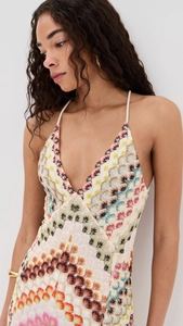 Détail d'une robe maxi bohème en crochet avec décolleté en V et motifs floraux colorés