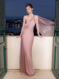 Elegant pink satin one-shoulder evening gown with cape detail and mermaid silhouette
