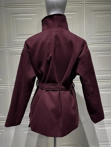 Rear view of wine red wool coat featuring a stand-up collar and matching waist belt detail