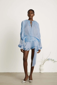 Detail of light blue tiered dress with pleated texture and stylish waist tie ribbon