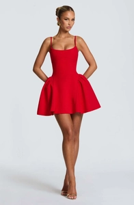 Detailed view of the layered pleats and structured hem on this red party mini dress