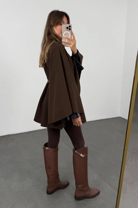 Detailed mirror selfie of a dark brown wool blend hooded poncho coat with a waist tie belt