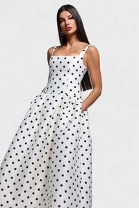 Vue détaillée d'une robe vintage blanche à pois avec poches latérales et jupe évasée