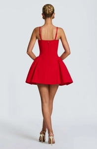 Back view of a red strapless mini dress with thin straps and a pleated A-line skirt