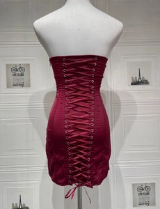 Close-up of wine red satin mini dress featuring corset-style lace-up back detail