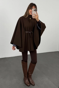 Detailed view of dark brown wool cape coat with a matching waist belt and leather boots