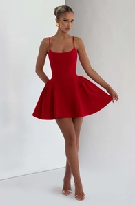 Detailed view of red mini dress featuring slim straps and voluminous pleated skirt