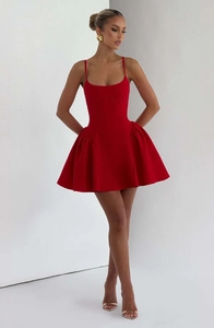Detail of red strapless mini dress featuring a corset bodice and voluminous pleated skirt