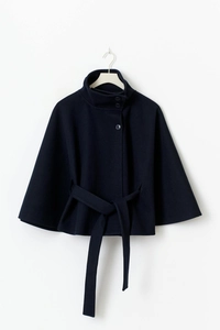 Detail of high collar and button closure on dark blue batwing wool blend cape coat