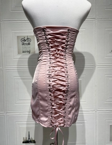 Pink satin corset dress detail featuring back criss-cross silk ribbon and metal eyelets