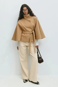 Detailed view of camel wool blend cape jacket with high collar and side buttons