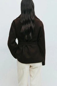 Detail of dark brown wool coat with waist tie and premium thick wool texture
