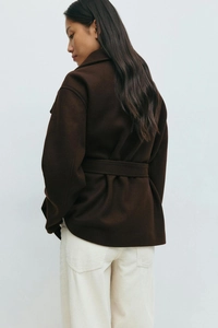 Rear view of a premium dark brown wool coat featuring a waist belt and thick winter texture