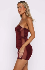 Detail of burgundy off-shoulder mini dress featuring sheer mesh patchwork and side zipper