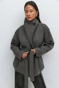 Detailed texture of dark grey wool coat with elegant high stand collar and single button