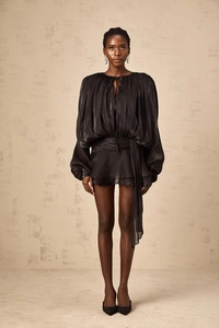 Detail of black pleated French bubble sleeve dress with drawstring and waist tie accents