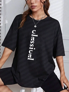 Women's black oversized cotton T-shirt with classical lettering in a casual loose fit