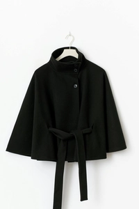 Detail of black wool cape jacket featuring high collar, single-breasted buttons and waist belt