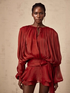 Deep red pleated puff sleeve blouse with lustrous fabric and elegant tie neck detail