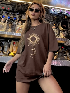 Detail of sun and moon celestial print on a brown oversized cotton t-shirt for women