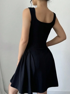 Chic black backless dress with a square neckline and pleated A-line skirt detail