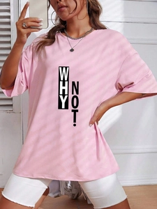 Detail of pink oversized t-shirt featuring bold WHY NOT! graphic and crew neck design