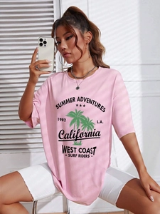 Detail of pink loose T-shirt featuring green palm tree print and Summer Adventures text