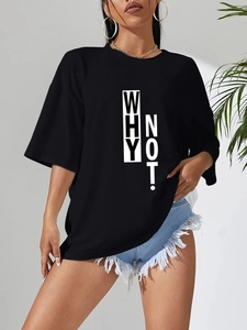 Close-up of a black oversized T-shirt featuring a vertical white 'WHY NOT!' print design