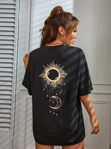 Women's black oversized t-shirt featuring celestial sun and moon graphic on the back