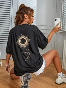 Black oversized t-shirt featuring golden sun and moon screen print on the back